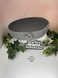 Gray rope basket with decorative knot