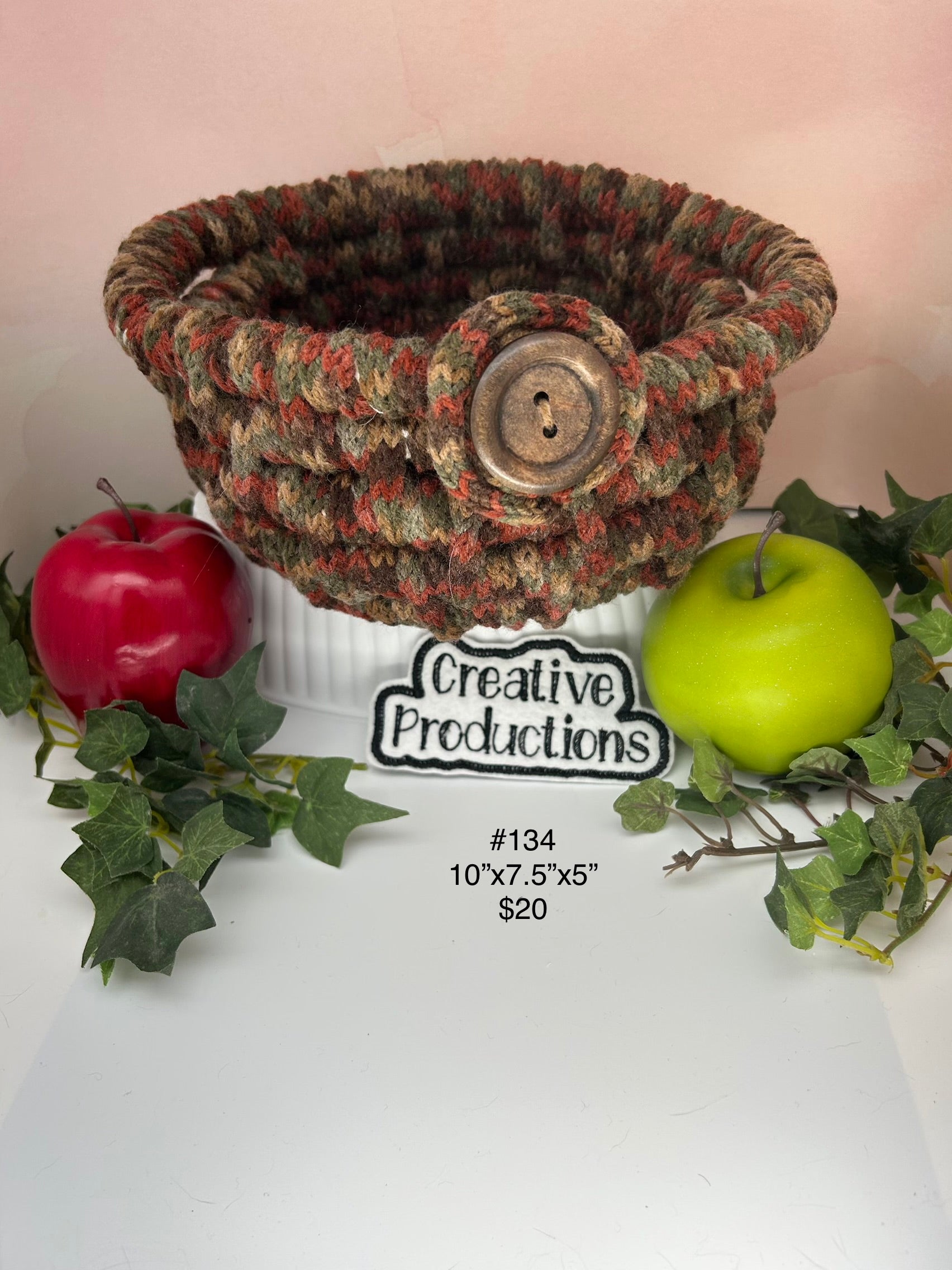 Coil wrapped rope basket in brown tones  with wooden button accent.