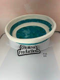 Natural colored rope basket with teal colored fabric insert and trim.