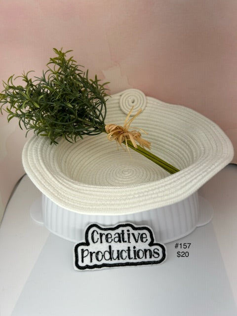 Natural colored rope basket with swirl knot accent.