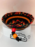 Black rope basket with chili pepper fabric insert.